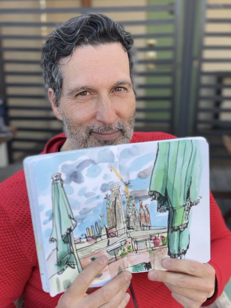 Swasky holding sketchbook